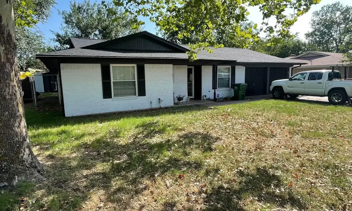 Professional roofing crew working on a residential roof in River Oaks